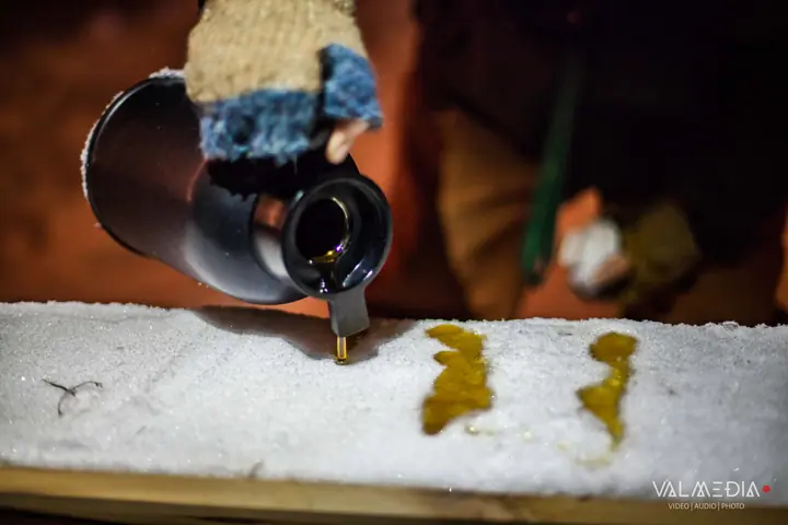 Hot syrup poured on snow to make maple taffy